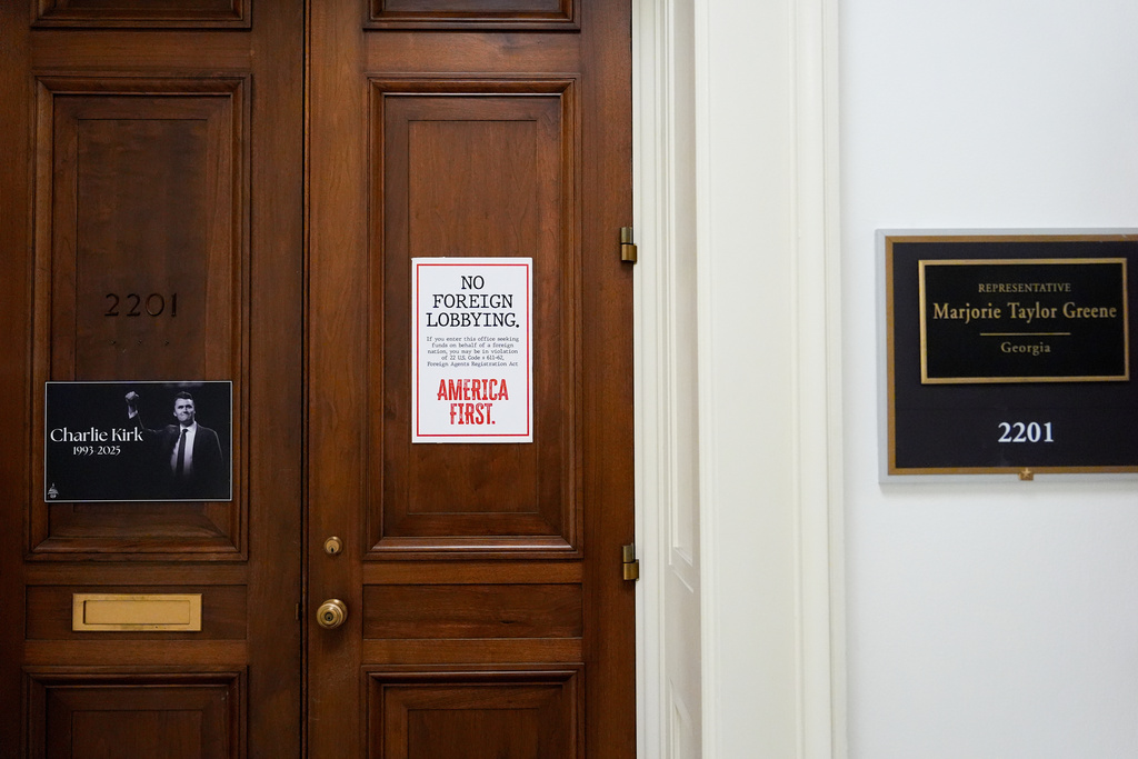 Posters hang on the doors of Rep. Marjorie Taylor Greene's, R-Ga., office at the Rayburn House Office Building, Tuesday, Nov. 18, 2025, on Capitol Hill in Washington. (AP Photo/Julia Demaree Nikhinson)