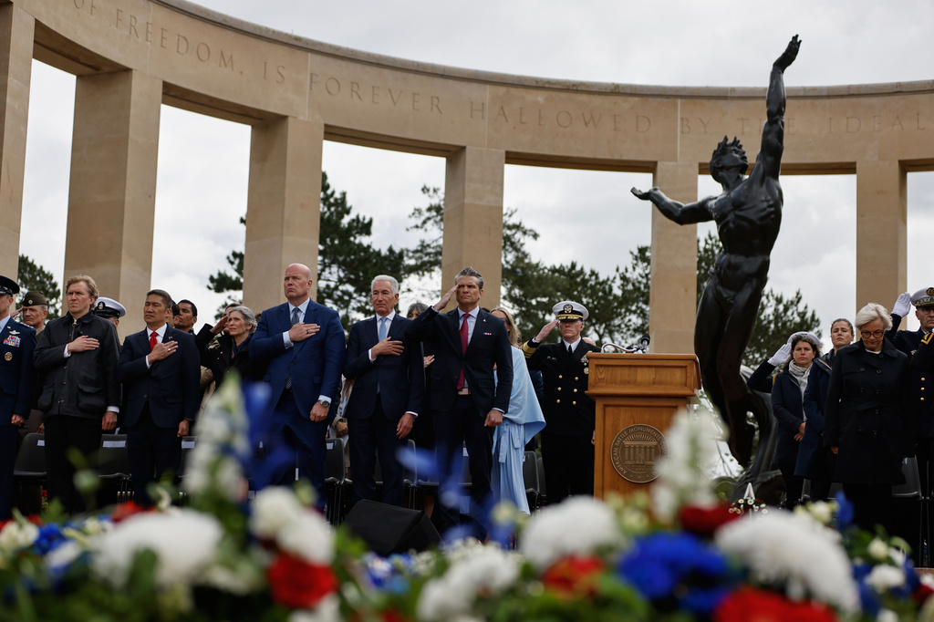 U.S. Defense Secretary Pete Hegseth, center, attends a ceremony at the US cemetery to commemorate the 82nd anniversary of the D-Day landings, in Colleville-sur-Mer, Normandy, France, Saturday, June 6, 2026. (AP Photo/Jeremias Gonzalez)