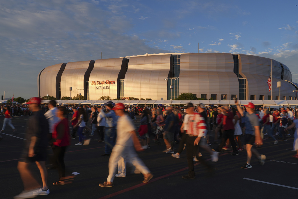 People wait in line before a memorial for conservative activist Charlie Kirk Sunday, Sept. 21, 2025, at State Farm Stadium in Glendale, Ariz. (AP Photo/Jae C. Hong)