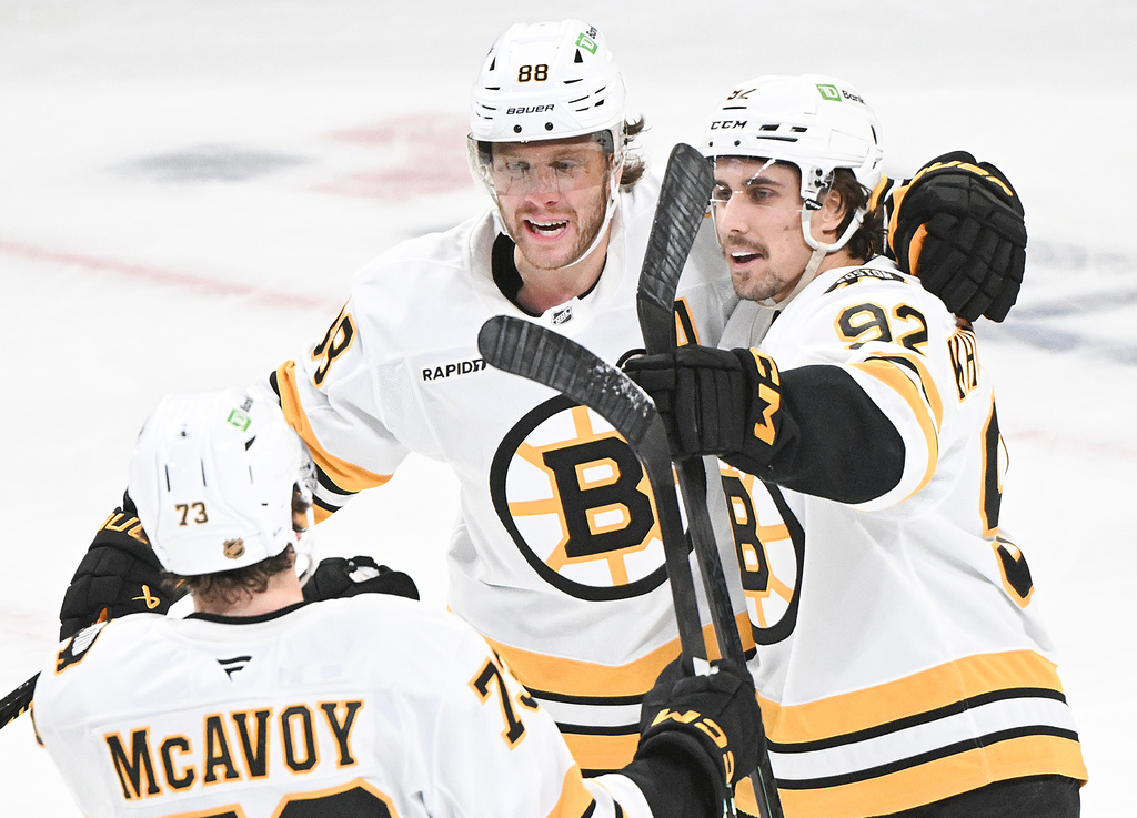 Boston Bruins' Marat Khusnutdinov (92) celebrates with teammates David Pastrnak (88) and Charlie McAvoy (73) after scoring against the Montreal Canadiens during the first period of an NHL hockey game in Montreal, Saturday, Nov. 15, 2025. (Graham Hughes/The Canadian Press via AP)