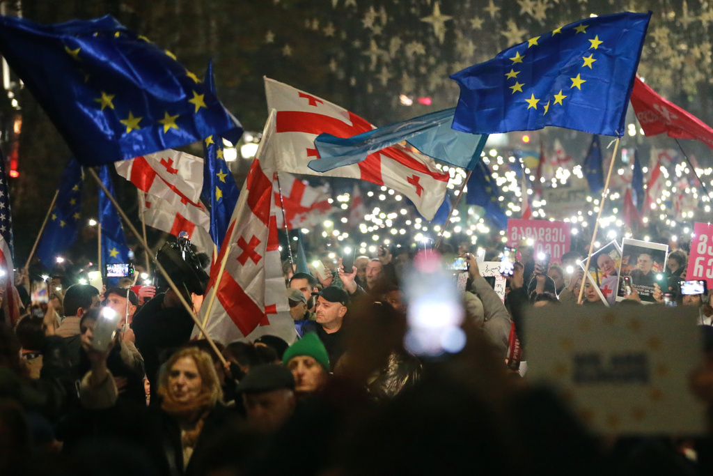 FILE - Demonstrators with Georgian and EU flags gather in the Georgian capital of Tbilisi, on Friday, Nov. 28, 2025, to mark 365 days of non-stop protests against the government's decision to halt talks on joining the European Union. (AP Photo/Zurab Tsertsvadze, file)