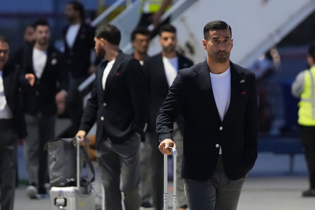 Iran's Ehsan Hajisafi, right, arrives with his teammates for the World Cup soccer tournament in Tijuana, Mexico, Sunday, June 7, 2026. (AP Photo/Gregory Bull)