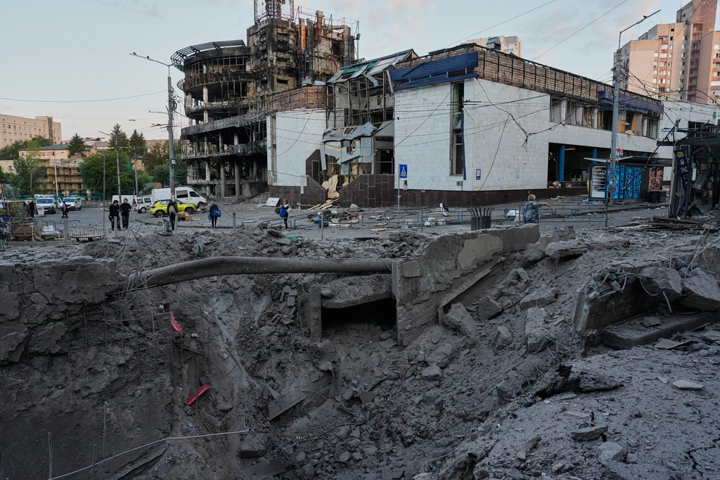 Debris surrounds a missile crater in the foreground of a building following Russia's missile attack in Kyiv, Ukraine, Sunday, July 19, 2026. (AP Photo/Efrem Lukatsky)