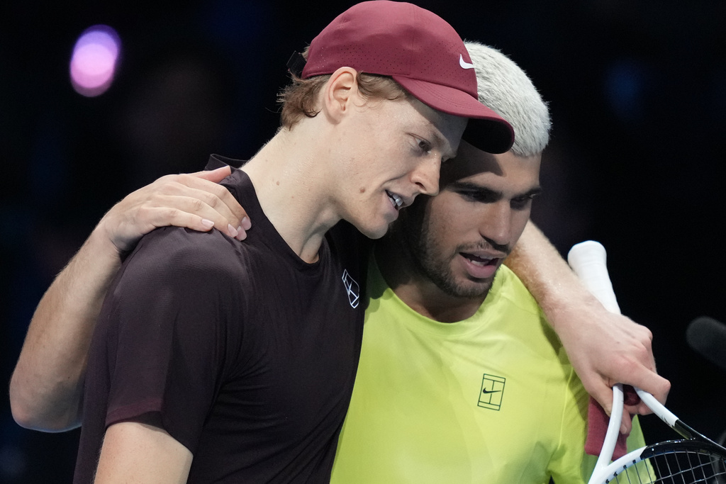 Italy's Jannik Sinner, left, and Spain's Carlos Alcaraz hug after the final tennis match of the ATP World Tour Finals, in Turin, Italy, Sunday, Nov. 16, 2025. (AP Photo/Antonio Calanni)