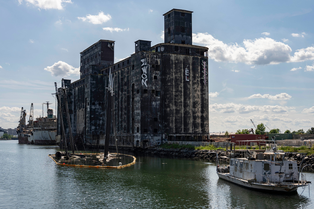 Debris of the Victory Chimes and the Pilot floats next to abandoned Red Hook Grain Terminal in the Henry Street Basin, Wednesday, Aug. 26, 2026, in the Brooklyn borough of New York. (AP Photo/Yuki Iwamura)