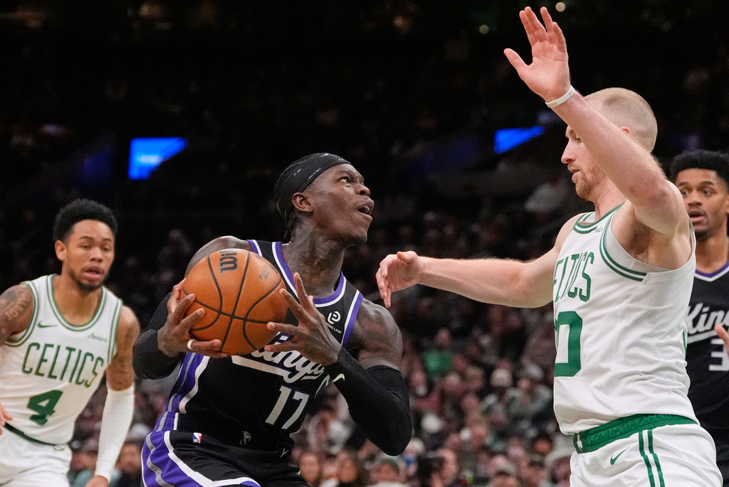 Sacramento Kings guard Dennis Schroder (17) drives to the basket against Boston Celtics forward Sam Hauser, front right, during the second half of an NBA basketball game, Friday, Jan. 30, 2026, in Boston. (AP Photo/Charles Krupa)
