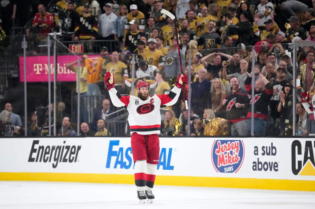 Carolina Hurricanes center Jordan Staal celebrates an empty net goal by left wing Nikolaj Ehlers during the third period in Game 4 of the NHL hockey Stanley Cup Final series against the Vegas Golden Knights, Tuesday, June 9, 2026, in Las Vegas. (AP Photo/John Locher)
