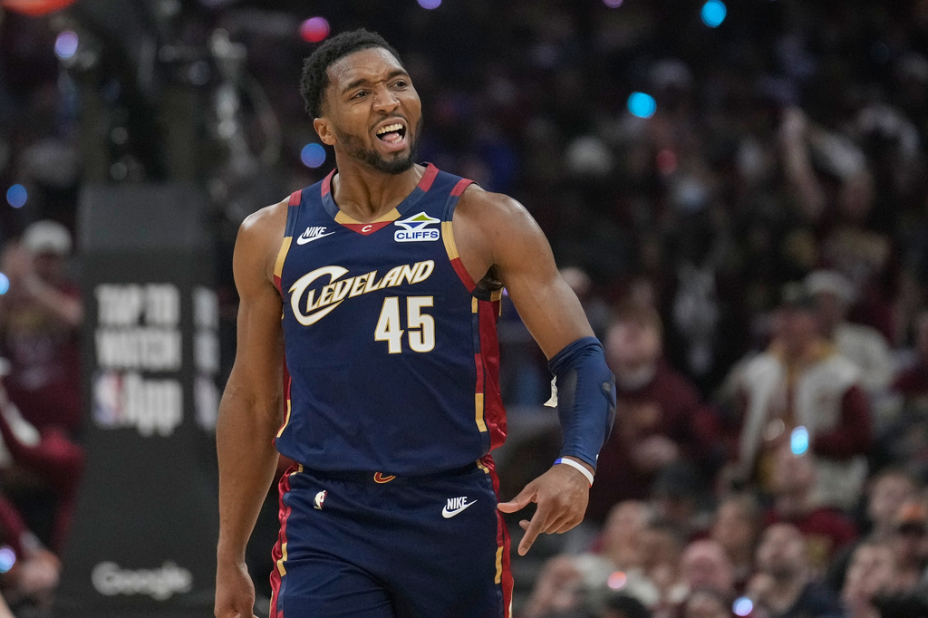 Cleveland Cavaliers guard Donovan Mitchell (45) gestures to the crowd in the first half in Game 2 of a first-round NBA basketball playoffs series against the Toronto Raptors in Cleveland, Monday, April 20, 2026. (AP Photo/Sue Ogrocki)