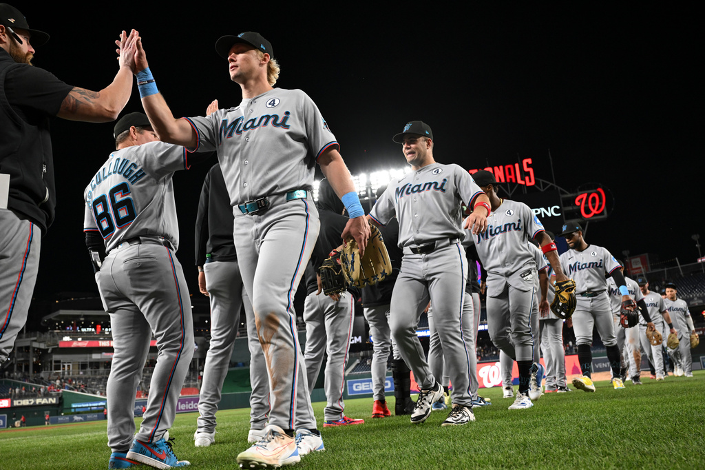 Miami Marlins players greet each other after defeating the Washington Nationals in a baseball game, Tuesday, June 2, 2026, in Washington. (AP Photo/Terrance Williams)