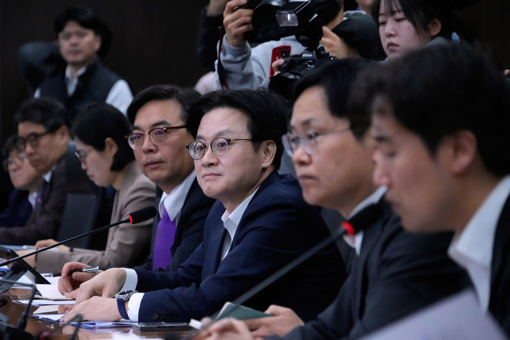 South Korean Trade Minister Kim Jung-kwan, third from right, attends a public-private joint meeting to discuss response to U.S. tariff policies in Seoul, South Korea, Monday, Feb. 23, 2026. (AP Photo/Ahn Young-joon)