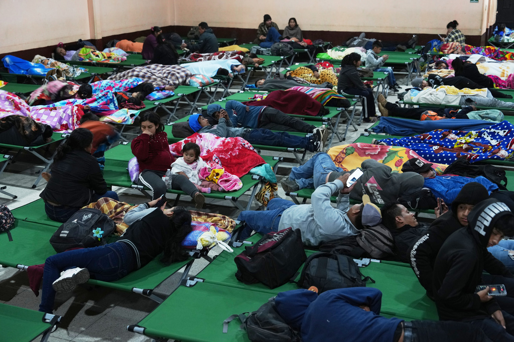 Families evacuated from areas surrounding the Fuego Volcano rest at a temporary shelter in San Juan Alotenango, Guatemala, Tuesday, Aug. 4, 2026. (AP Photo/Moises Castillo)