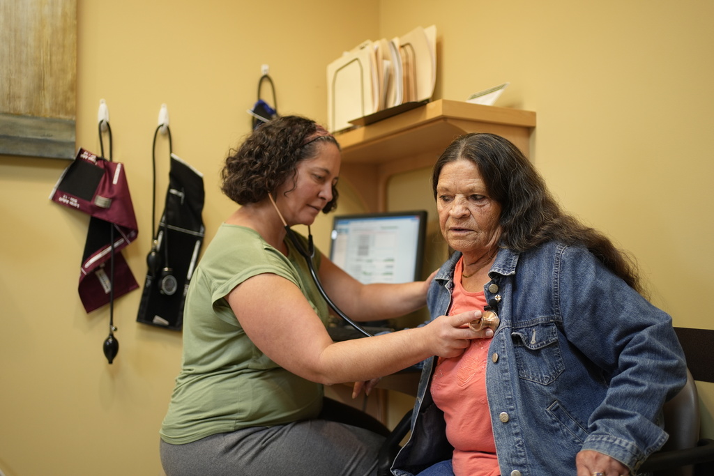 Dr. Melissa Buddensee, left, meets with patient Susan Bushby at Ammonoosuc Community Health Services, Tuesday, Oct. 21, 2025, in Franconia, N.H., in the final days before the clinic closes for good. (AP Photo/Robert F. Bukaty)