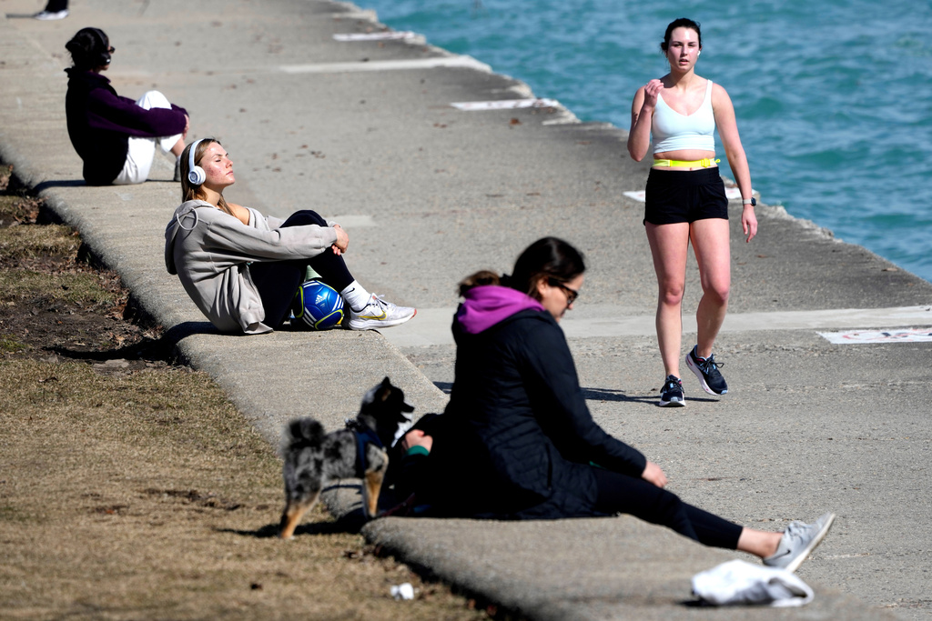FILE - Pedestrians take in the warmer than normal temperatures near the North Avenue Beach Pier along Lake Michigan Feb. 26, 2024, in Chicago. (AP Photo/Charles Rex Arbogast, FIle)