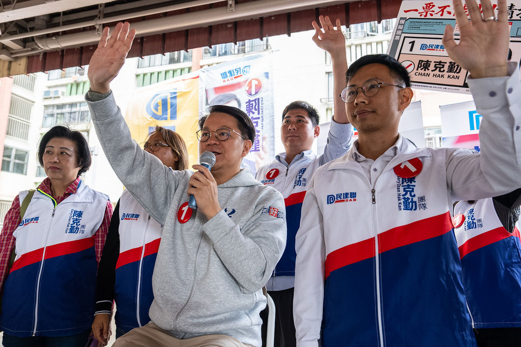 Gary Chan, candidates of the Legislative Council Election, center, campaigns on the street during the Legislative Council General Election in Hong Kong on Sunday, Dec. 7, 2025. (AP Photo/Chan Long Hei)