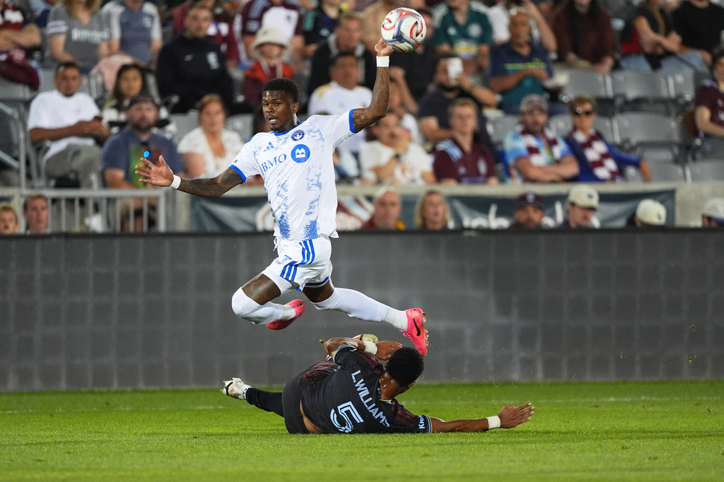 CF Montréal defender Brayan Ceballos, top, flies over Colorado Rapids defender Loïc Williams in the first half of an MLS soccer match Saturday, Sept. 12, 2026, in Dick's Sporting Goods Park in Commerce City, Colo. (AP Photo/David Zalubowski)