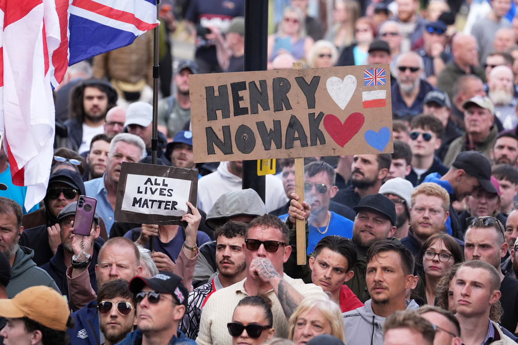 People gather to protest outside Southampton police station, Southampton, England, Tuesday June 2, 2026, after the fatal stabbing of Henry Nowak, a British teenager who was handcuffed despite claiming he was the crime victim. (Gareth Fuller/PA via AP)
