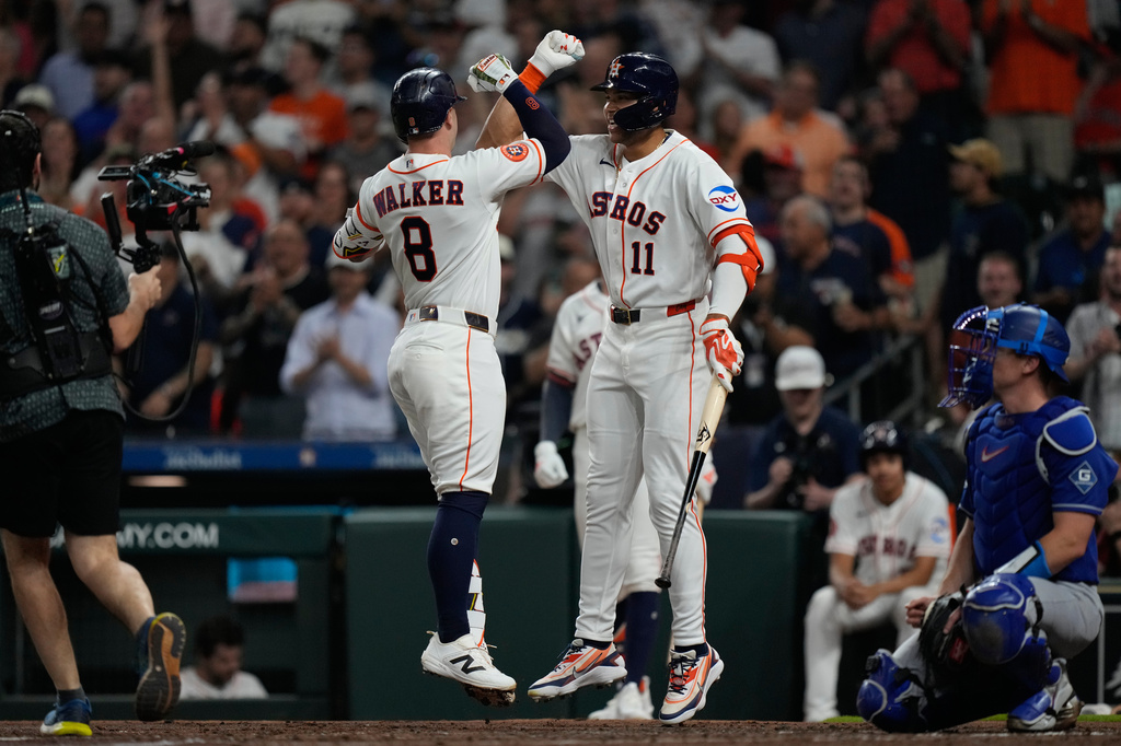 Houston Astros designated hitter Christian Walker (8) celebrates with Cam Smith after hitting a home run during the second inning of a baseball game against the Los Angeles Dodgers in Houston, Tuesday, May 5, 2026. (AP Photo/Ashley Landis)