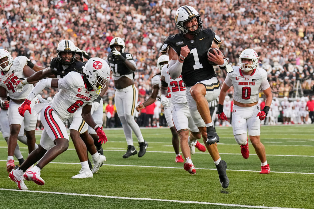 Vanderbilt quarterback Blaze Berlowitz (1) runs into the end zone to score a touchdown during the first half of an NCAA college football game against Austin Peay, Saturday, Sept. 5, 2026, in Nashville, Tenn. (AP Photo/George Walker IV)
