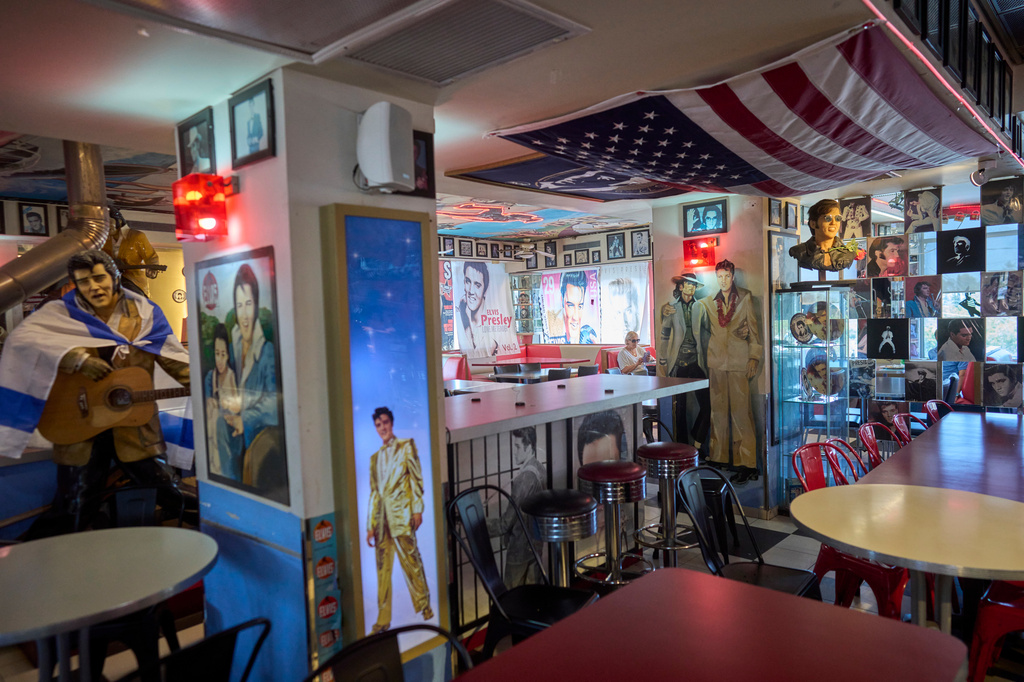 A man eats lunch in the Elvis Inn restaurant at a gas station in Neve Ilan, between Jerusalem and Tel Aviv, Israel, Thursday, June 25, 2026. (AP Photo/Ohad Zwigenberg)