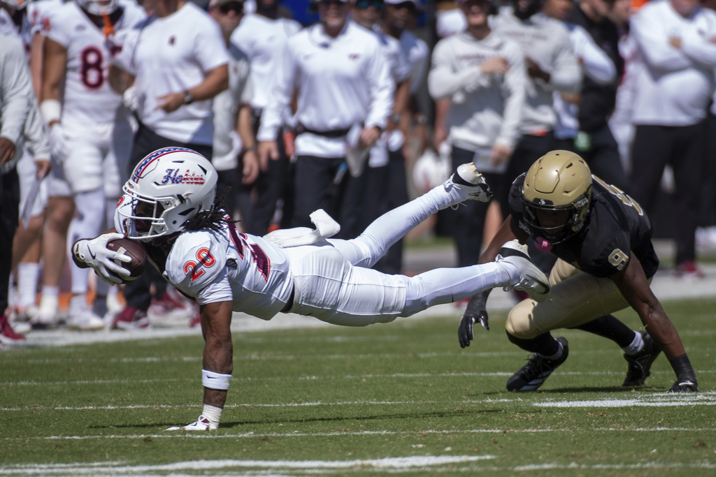 Virginia Tech running back P.J. Prioleau (20) dives for yardage against Wofford during the first half of an NCAA college football game Saturday, Sept. 20 2025, in Blacksburg, Va. (AP Photo/Robert Simmons)