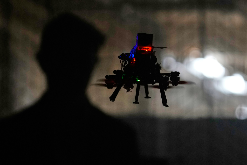 Colin Balfour, a sophomore studying robotics engineering, flies a small drone at a simulated night flight at a laboratory at the Worcester Polytechnic Institute, Monday, Oct. 20, 2025, in Worcester, Mass. (AP Photo/Charles Krupa)