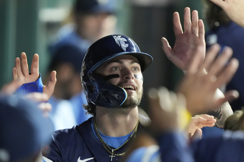Kansas City Royals' Carter Jensen celebrates in the dugout after scoring on a single by Vinnie Pasquantino during the third inning of a baseball game against the Toronto Blue Jays, Friday, Sept. 19, 2025, in Kansas City, Mo. (AP Photo/Charlie Riedel)