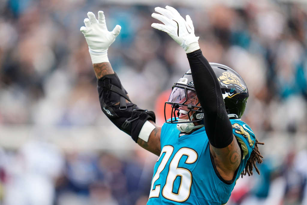 Jacksonville Jaguars safety Antonio Johnson (26) celebrates a defensive stop during the first half of an NFL football game against the Tennessee Titans, Sunday, Jan. 4, 2026, in Jacksonville, Fla. (AP Photo/John Raoux)