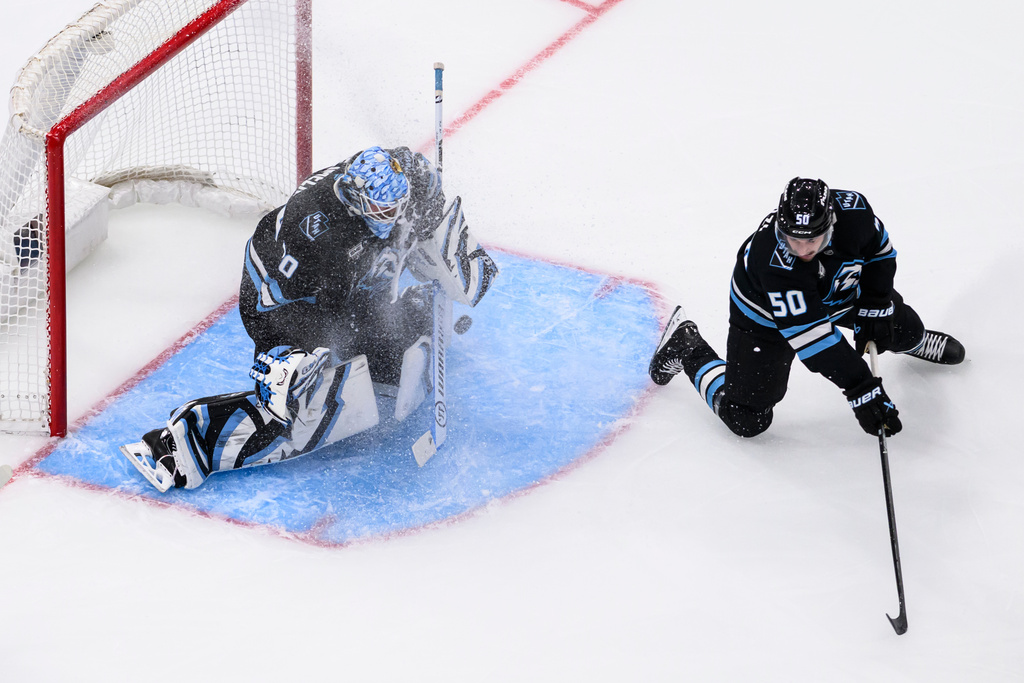 Utah Mammoth goaltender Karel Vejmelka, left, blocks the puck with defensive help from defenseman Sean Durzi (50) during the first period of an NHL hockey game against the Minnesota Wild, Friday, Feb. 27, 2026, in Salt Lake City. (AP Photo/Tyler Tate)