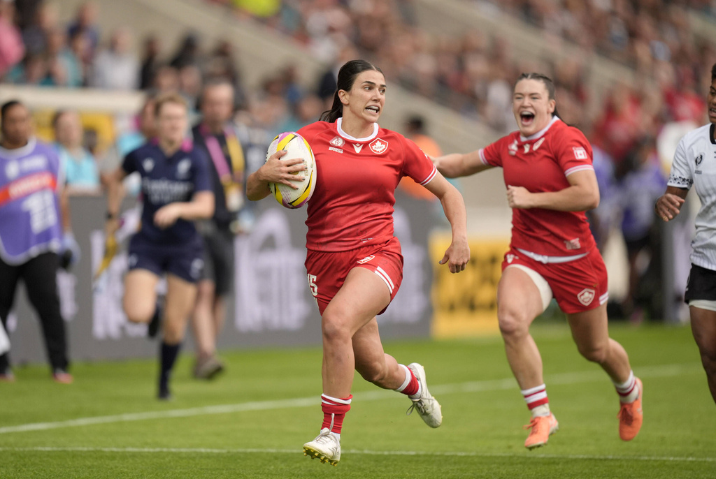 Canada's Julia Schell breaks through and scores a try during the Women's Rugby World Cup 2025 Pool B match between Canada and Fiji at the York Community Stadium in York, England, Saturday, Aug. 23, 2025. (Danny Lawson/PA via AP)