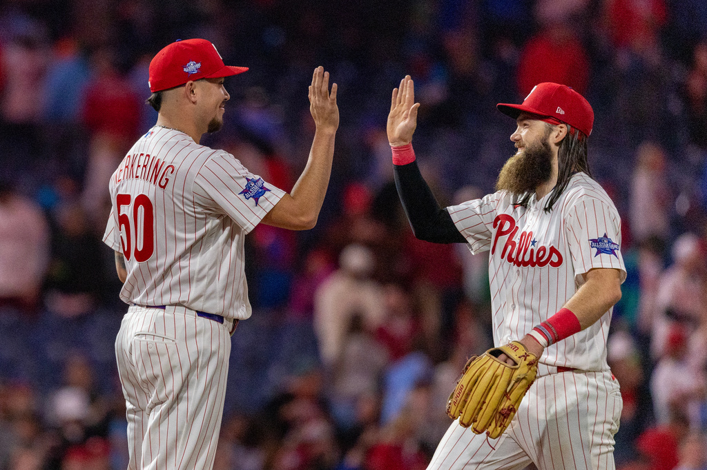 Philadelphia Phillies closing pitcher Orion Kerkering (50) is congratulated by left fielder Brandon Marsh after their team defeated the Colorado Rockies in a baseball game, Saturday, May 9, 2026, in Philadelphia. (AP Photo/Laurence Kesterson)