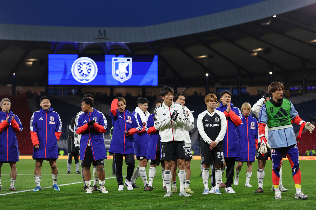 Japan's players celebrate their victory at the international friendly soccer match between Scotland and Japan in Glasgow, Scotland, Saturday, March 28, 2026. (AP Photo/Scott Heppell)