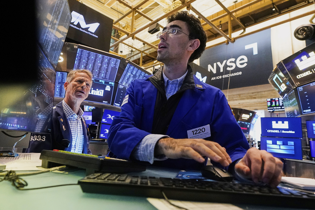 Specialist Alex Weitzman, right, works at his post on the floor of the New York Stock Exchange, Friday, Aug. 15, 2025. (AP Photo/Richard Drew)