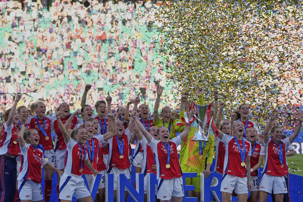 FILE - Arsenal players celebrate with their trophy after winning the women's Champions League final soccer match between Arsenal and FC Barcelona at the Jose Alvalade stadium in Lisbon, Saturday, May 24, 2025. (AP Photo/Armando Franca, File)