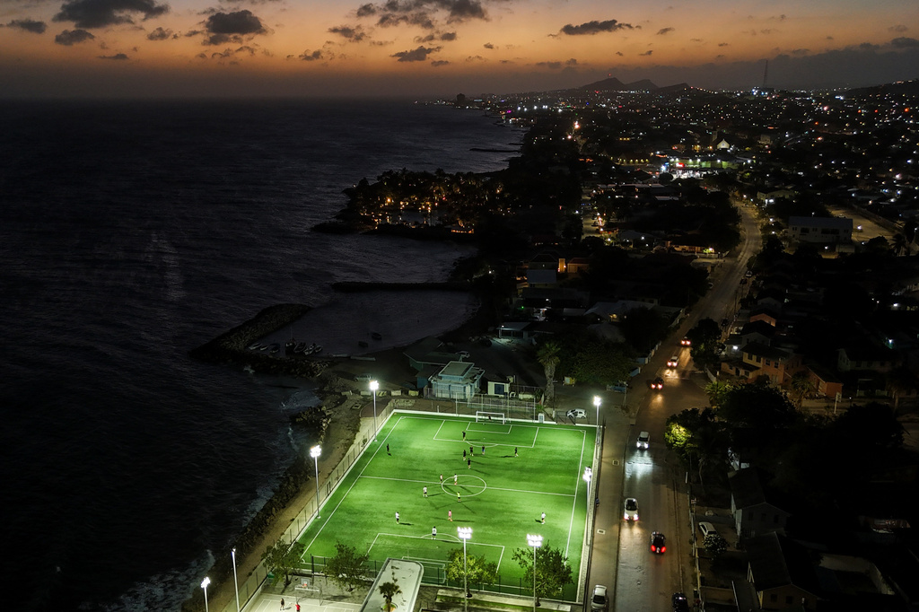 People play soccer in Willemstad, Curacao, Saturday, May 16, 2026. (AP Photo/Matias Delacroix)