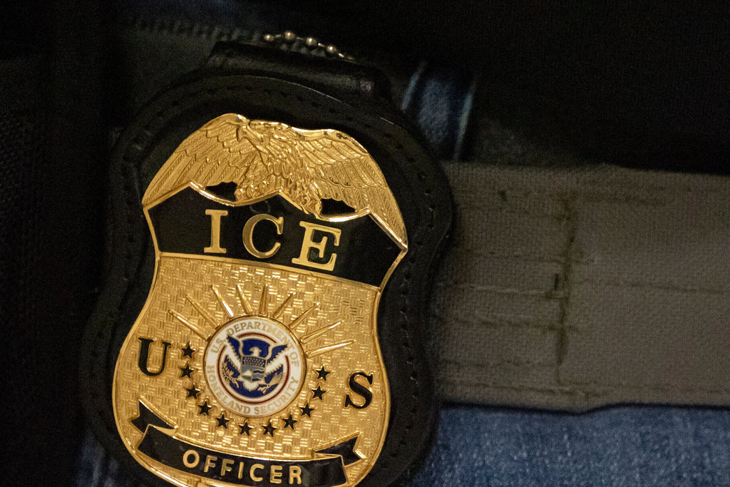 FILE - A federal agent wears an Immigration and Customs Enforcement badge in New York, June 10, 2025. (AP Photo/Yuki Iwamura, File)