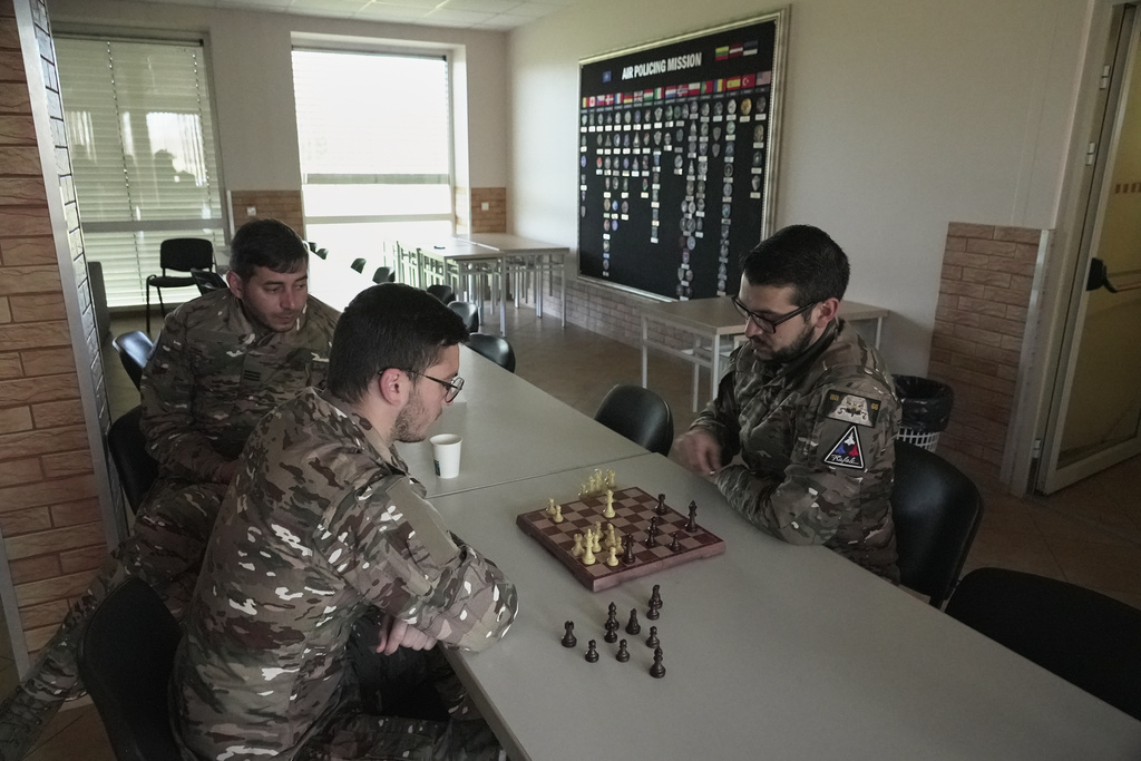 Members of a French air force detachment of personnel and Rafale jets stationed on a monthslong deployment at the Siauliai Air Base in Lithuania on a NATO air-policing mission play chess in the detachment's headquarters at the base on Monday, April 20, 2026. (AP Photo/John Leicester)