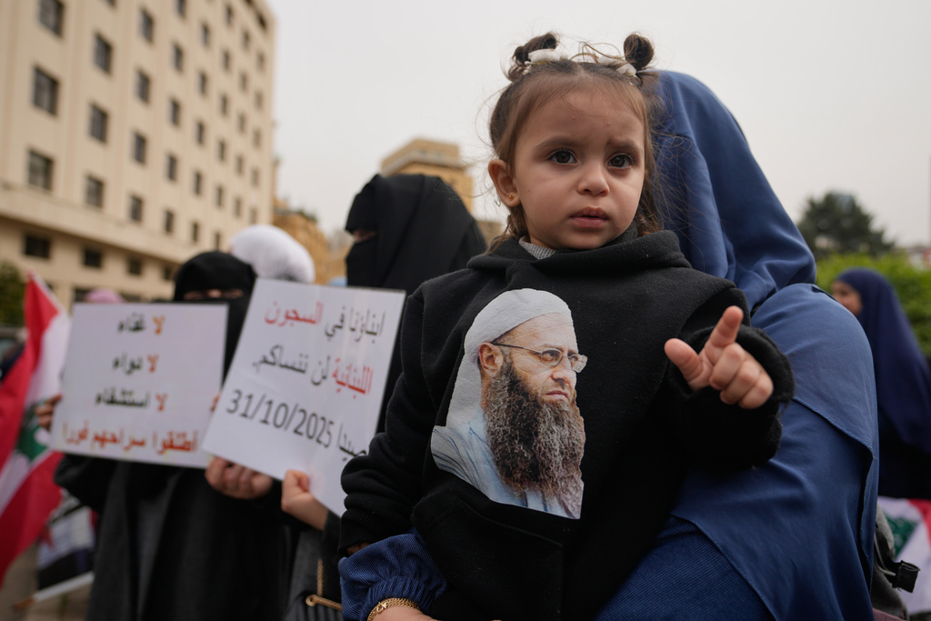 A child wears a sweatshirt bearing a portrait of imprisoned Sunni cleric Ahmad al-Assir during a protest demanding a general amnesty for Islamic groups and other prisoners, in downtown Beirut, Lebanon, Friday, Jan. 30, 2026. (AP Photo/Hassan Ammar)