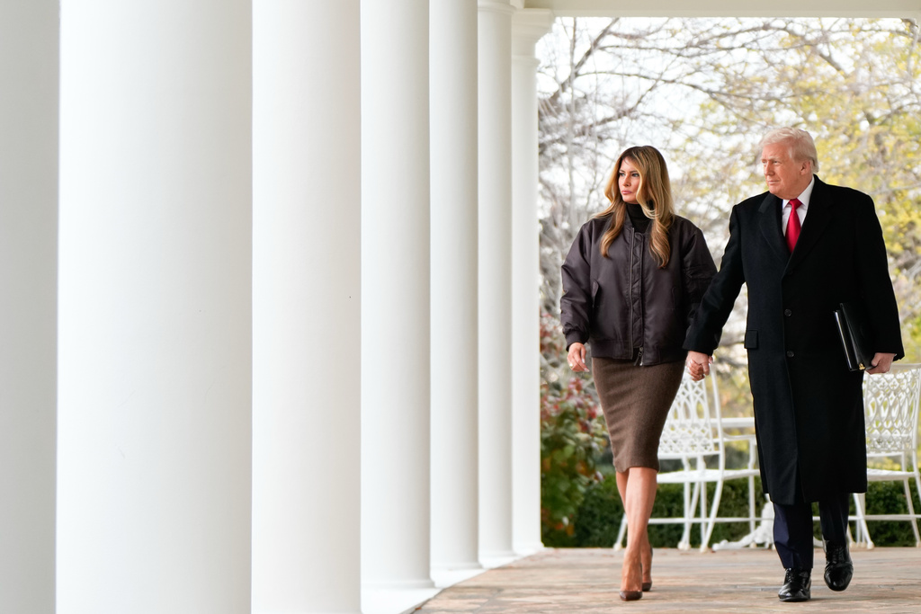 President Donald Trump and first lady Melania Trump walk out to participate in a pardoning ceremony of the national Thanksgiving turkeys Waddle and Gobble, in the Rose Garden of the White House, Tuesday, Nov. 25, 2025, in Washington. (AP Photo/Julia Demaree Nikhinson)