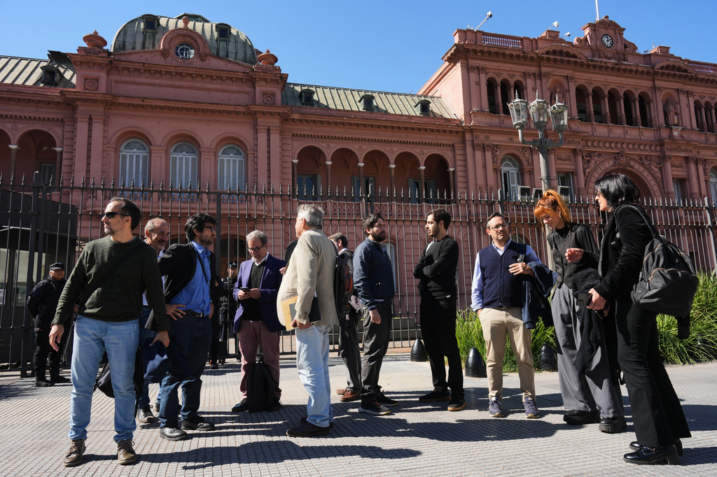 Journalists stand outside of the Casa Rosada government headquarters after President Javier Milei blocked their access, in Buenos Aires, Argentina, Thursday, April 23, 2026. (AP Photo/Rodrigo Abd)