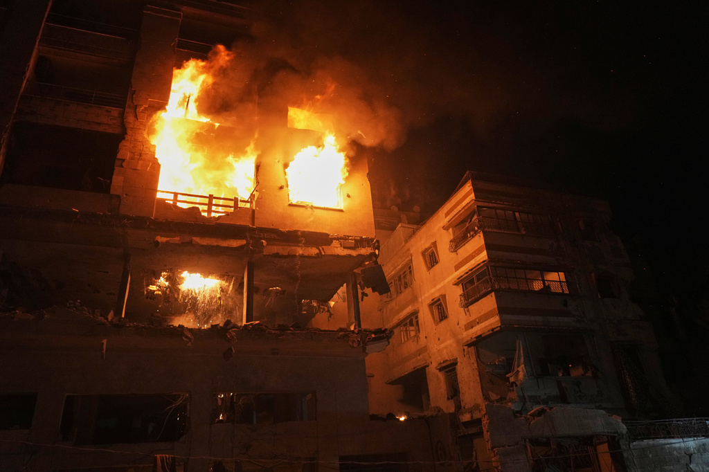 Flames engulf a residential building following an Israeli strike in the Rimal neighborhood in Gaza City, Friday, May 15, 2026. (AP Photo/Jehad Alshrafi)
