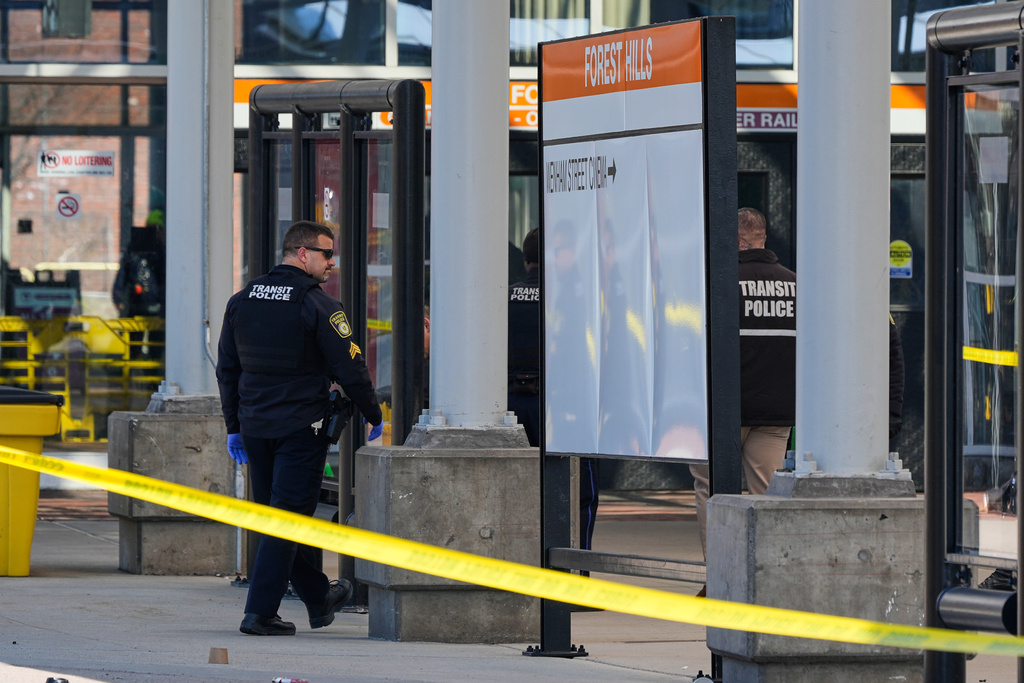 Law enforcement officials work a crime scene at the Forest Hills train station in the Jamaica Plain neighborhood, Friday, March 20, 2026, in Boston. (AP Photo/Charles Krupa)