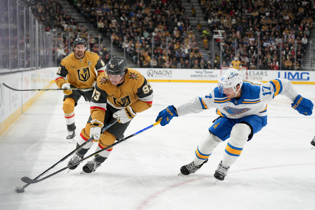 Vegas Golden Knights right wing Mitch Marner (93) skates with the puck against St. Louis Blues defenseman Cam Fowler (17) during the second period of an NHL hockey game Saturday, Jan. 10, 2026, in Las Vegas. (AP Photo/Candice Ward)