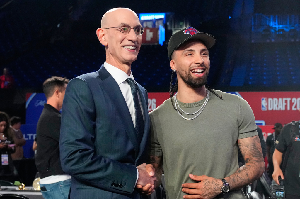 NBA Commissioner Adam Silver, left, and New York Knicks' Jose Alvarado, right, pose for a photo before the NBA basketball draft, Tuesday, June 23, 2026, in New York. (AP Photo/Yuki Iwamura)