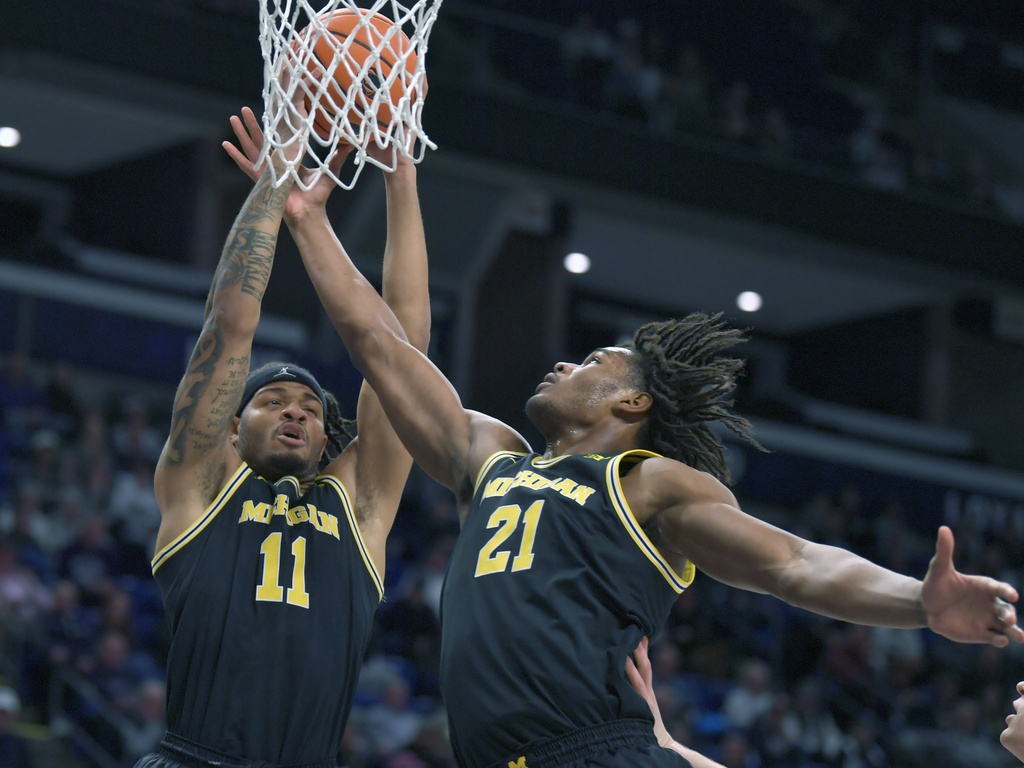 Michigan's Roddy Gayle Jr. (11) and Morez Johnson Jr. (21) go up for a rebound against Penn State during the first half of an NCAA college basketball game Tuesday, Jan. 6, 2026, in State College, Pa. (AP Photo/Gary M. Baranec)
