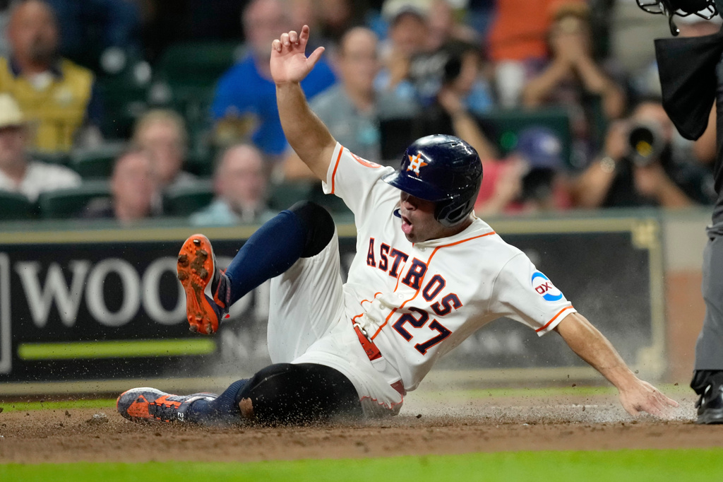 Houston Astros' Jose Altuve reacts after scoring against the Toronto Blue Jays during the fourth inning of a baseball game Tuesday, Aug. 4, 2026, in Houston. (AP Photo/David J. Phillip))