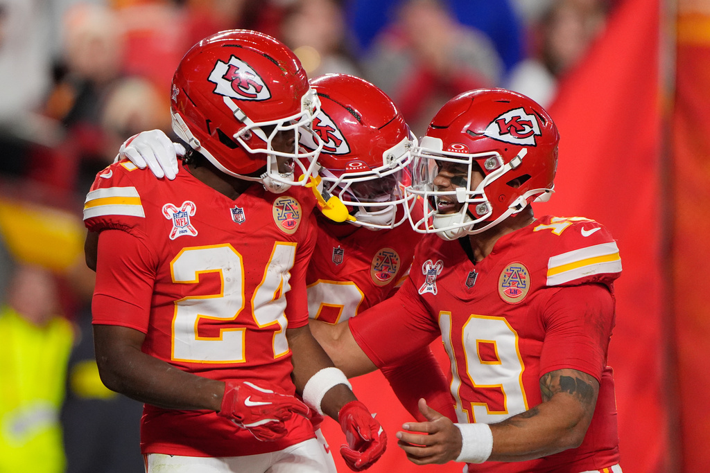 Kansas City Chiefs running back Brashard Smith (24) celebrates with wide receiver Juju Smith-Schuster, center, and quarterback Chris Oladokun (19) after scoring a touchdown during the first half of an NFL football game against the Denver Broncos Thursday, Dec. 25, 2025, in Kansas City, Mo. (AP Photo/Charlie Riedel)