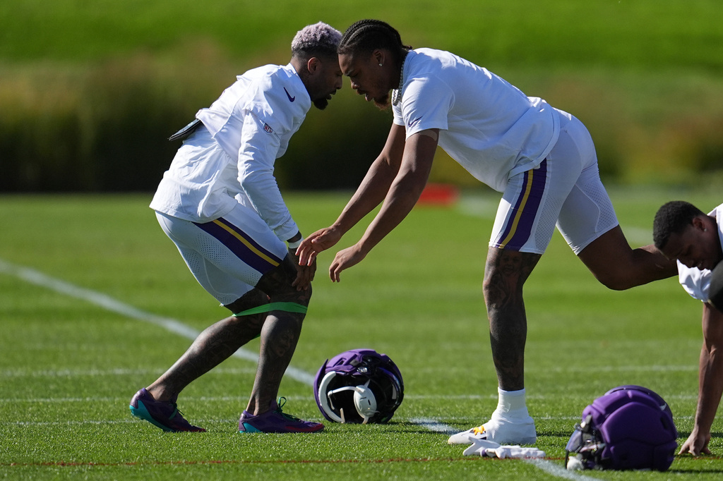 Minnesota Vikings wide receivers Odell Beckham Jr., left, and Justin Jefferson, middle, stretch during an NFL football practice Wednesday, Oct. 7, 2026, in Eagan, Minn. (AP Photo/Abbie Parr)