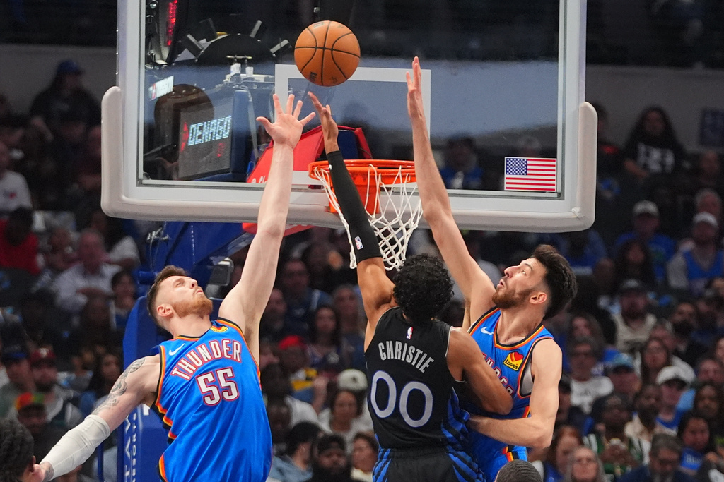 Oklahoma City Thunder centers Isaiah Hartenstein (55) and Chet Holmgren, right, defend the basket against Dallas Mavericks guard Max Christie (00) during the first half of an NBA basketball game in Dallas, Sunday, March 1, 2026. (AP Photo/LM Otero)