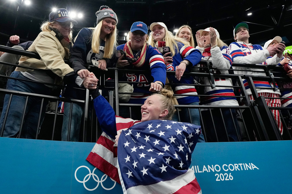 FILE - United States' Grace Zumwinkle (13) shakes hands with fans after United States' women's ice hockey team was presented with the gold medals at the 2026 Winter Olympics, in Milan, Italy, Feb. 19, 2026. (AP Photo/Petr David Josek, File)