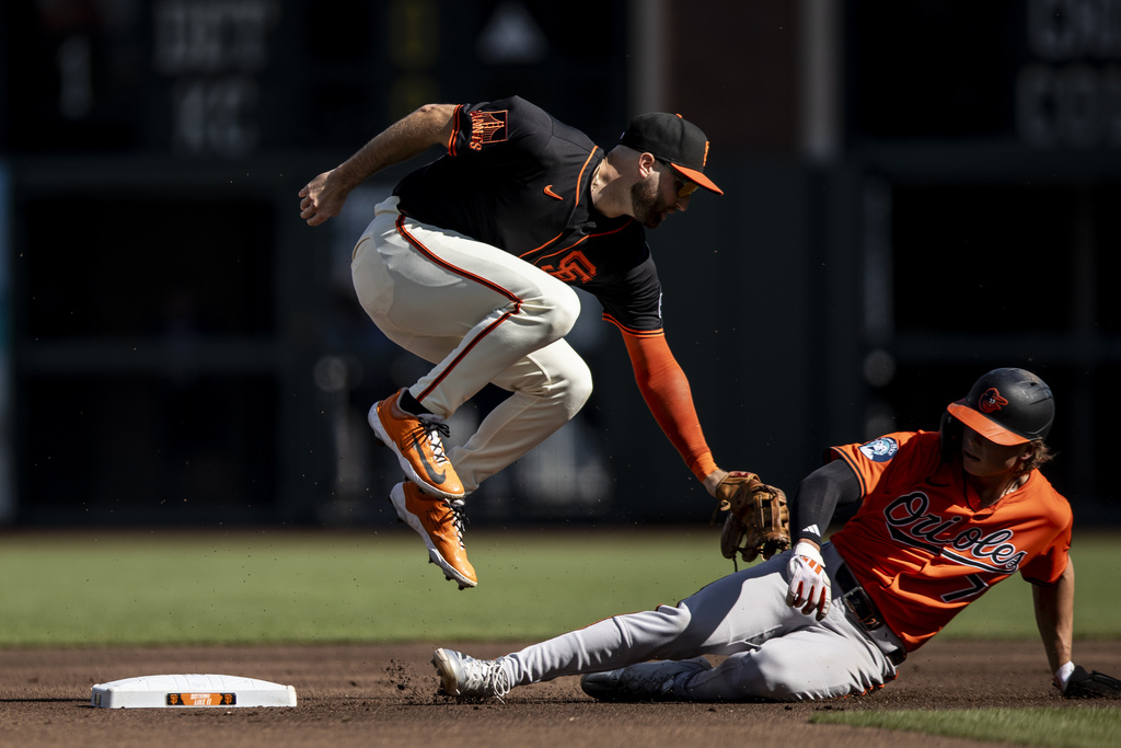 San Francisco Giants second baseman Casey Schmitt can't force out Baltimore Orioles' Jackson Holliday on a throwing error by teammate shortstop Willy Adames during the first inning of a baseball game in San Francisco, Saturday, Aug. 30, 2025. (Stephen Lam/San Francisco Chronicle via AP)